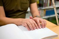 Someone using assistive technology to read a book