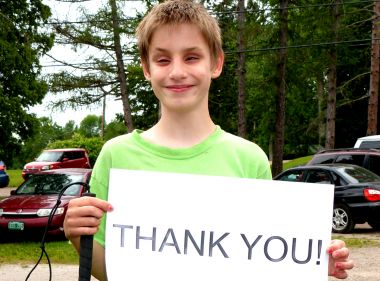boy holding thank you sign